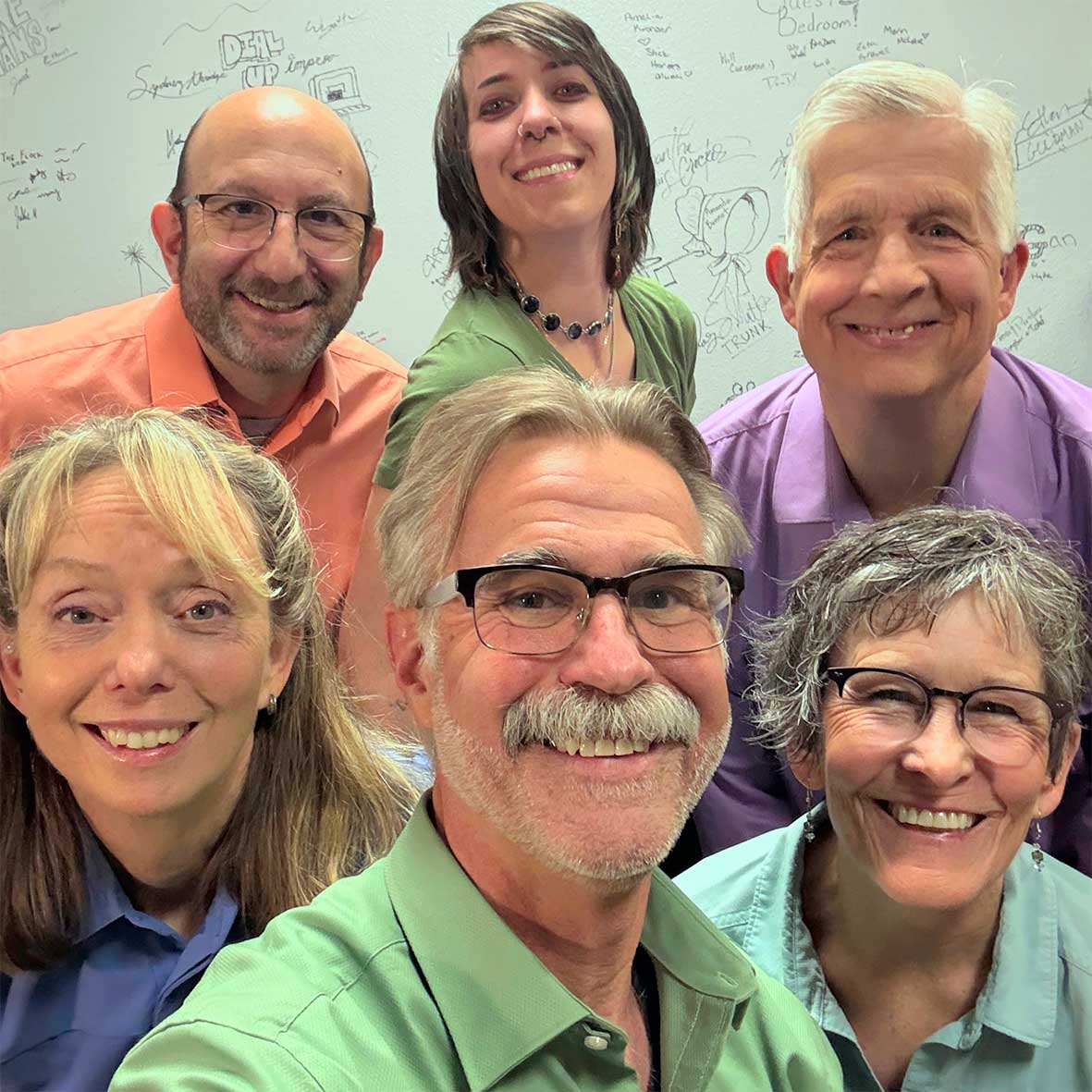 All members of the Improv Colorado Troupe, looking at the camera with big smiles